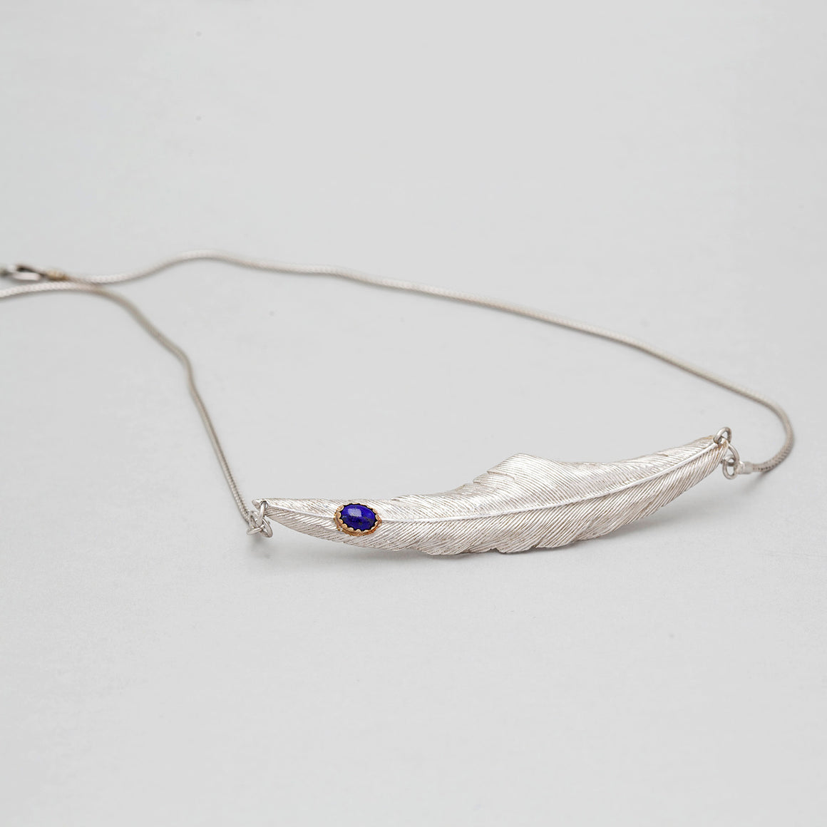 STERLING SILVER FEATHER NECKLACE WITH LAPIS IN GOLD CAP