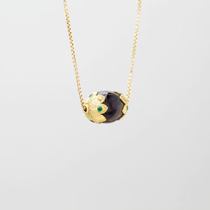 BLACK CORAL PENDANT WITH GOLD AND EMERALD ENCASEMENT