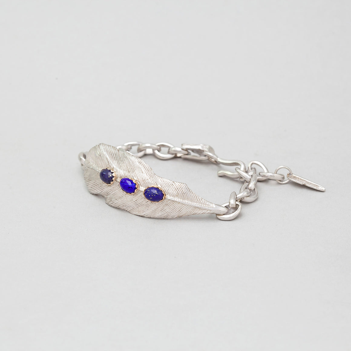 STERLING SILVER FEATHER CHAIN LINK BRACELET WITH LAPIS ACCENT IN GOLD CAP