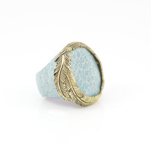 OXOTIC SKIN RING IN SKY WITH YELLOW BRASS FEATHER CROWN